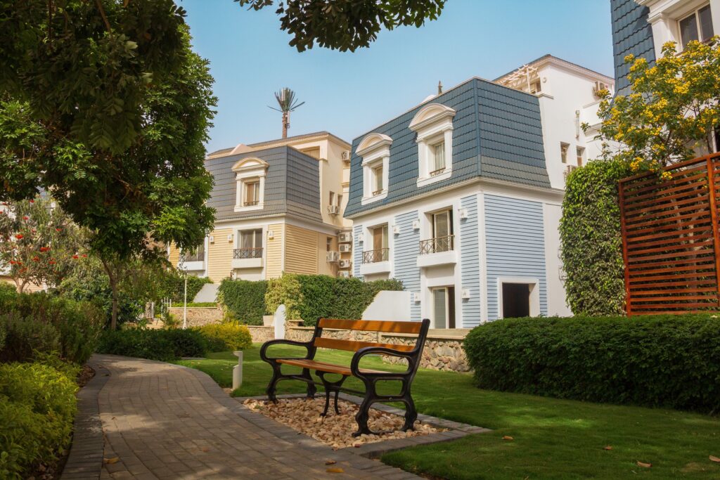 Modern residential buildings in a lush garden setting, perfect for relaxation in Giza, Egypt.