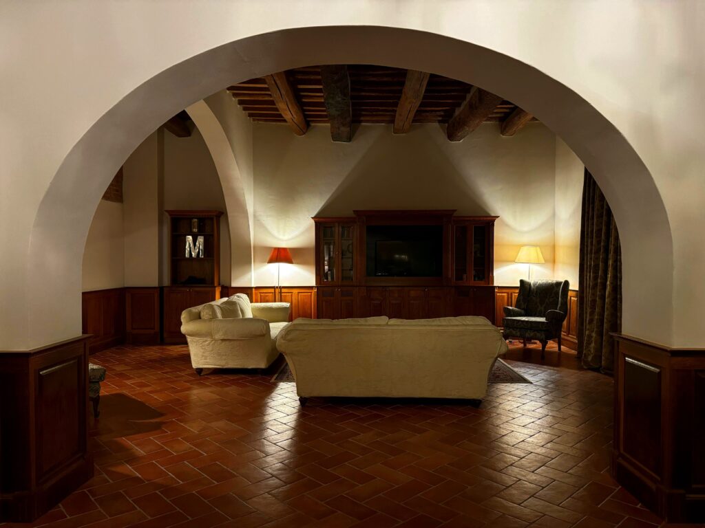 Elegant living room in Colleoli, Tuscany featuring classic furniture and warm lighting.